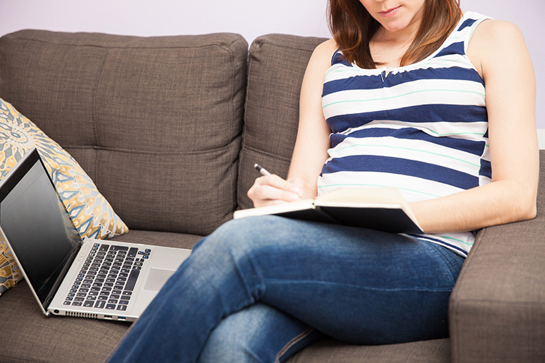 pregnant woman writing a list