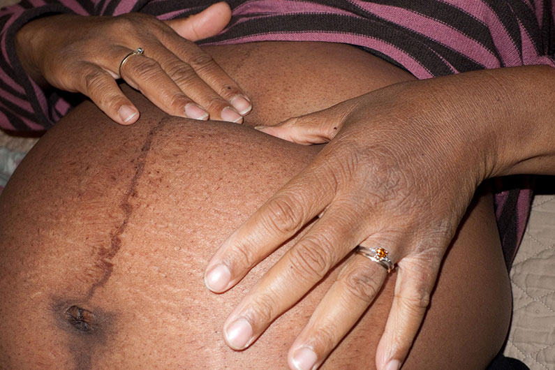 pregnant woman touching belly