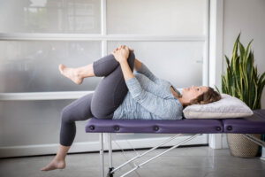 woman does psoas release off of a massage table