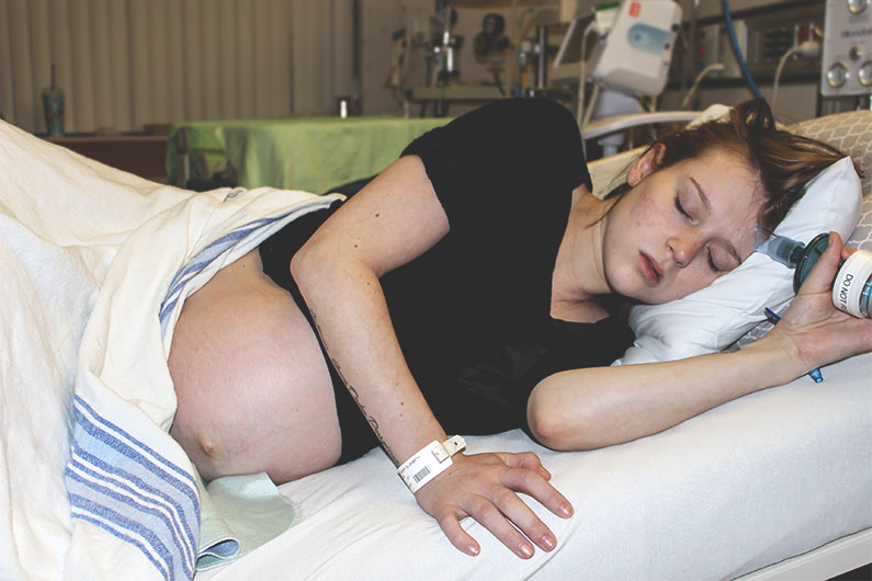 woman in labor laying on side