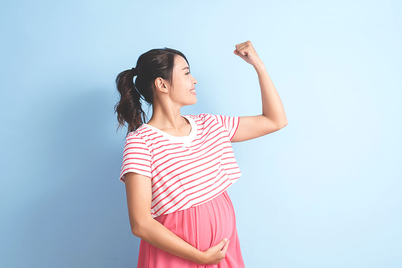 pregnant woman flexing