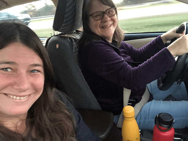 Gail and Jen smile from the car.
